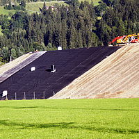 Workers in the process of laying Enkadrain drainage mat for efficient drainage and drainage on the construction site.